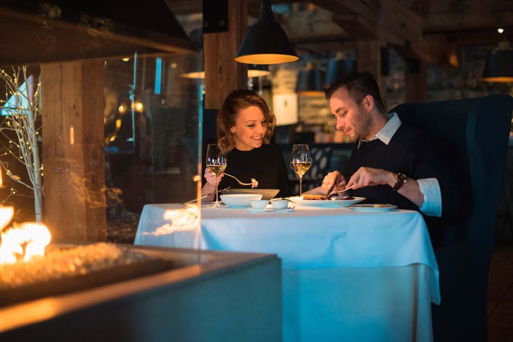 A couple enjoys the gastronomy and the romantic atmosphere at the Auberge Saint-Antoine restaurant, Chez Muffy.