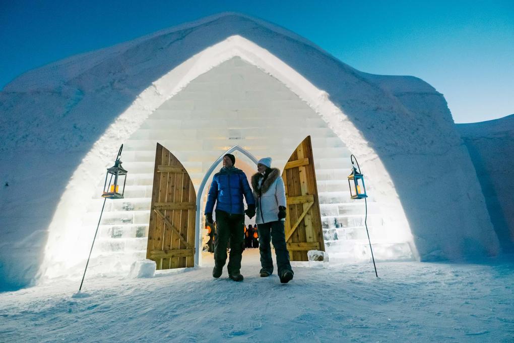 Un couple devant l'Hôtel de Glace le soir