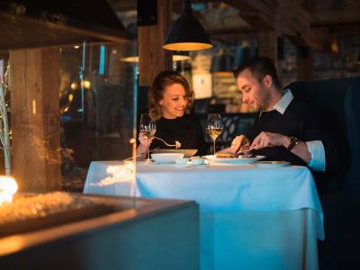  A couple enjoys the gastronomy and the romantic atmosphere at the Auberge Saint-Antoine restaurant, Chez Muffy.