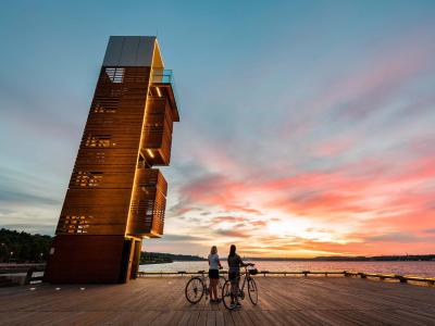 Two cyclists contemplate the sunrise on the Samuel-De Champlain promenade, from the Quai des Cageux.